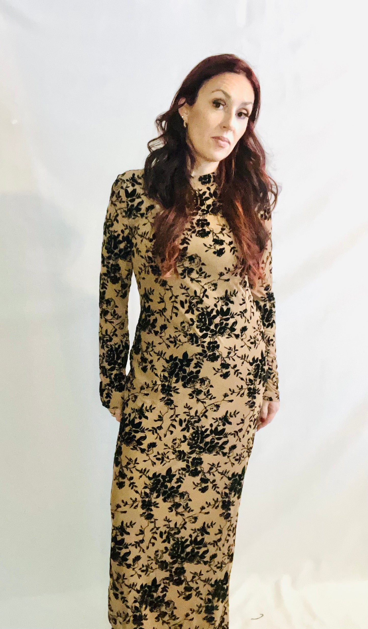 Woman wearing a floral dress against a white background