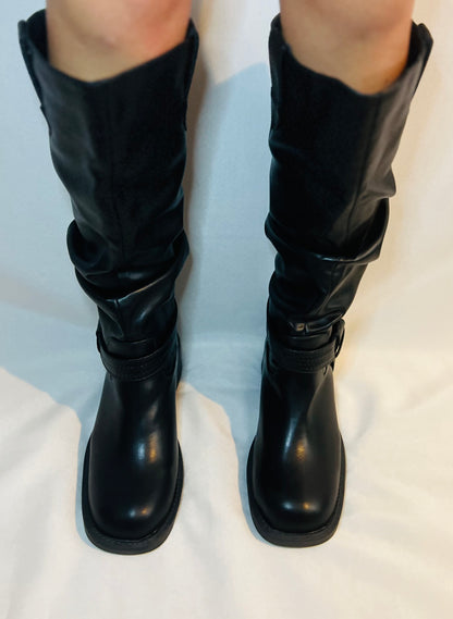 Black knee-high boots on a white background
