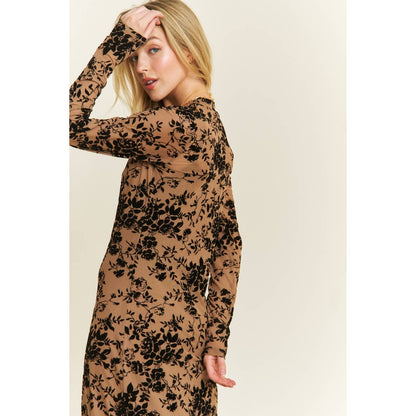 Woman wearing a brown dress with black floral patterns on a beige background