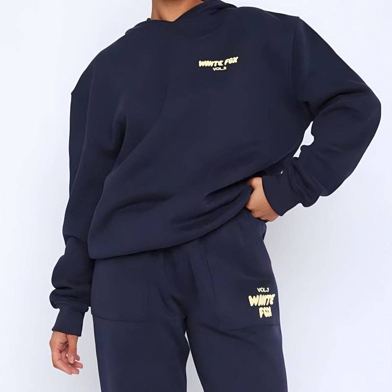 Person wearing a navy blue sweatshirt and pants with 'White Fox' branding on a white background