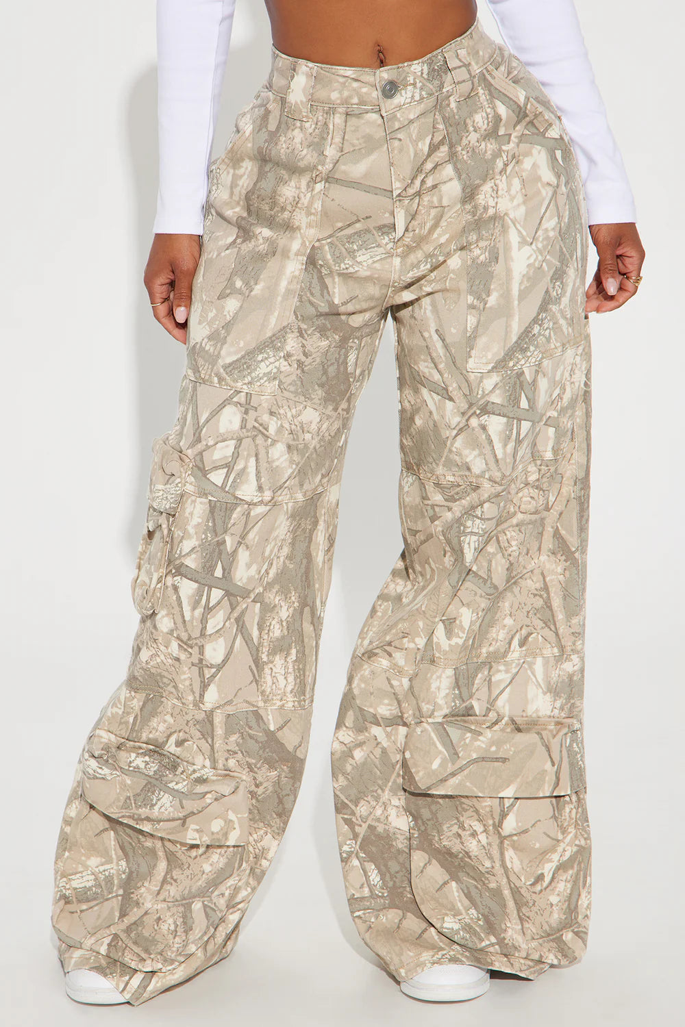 Camouflage cargo pants worn by a person on a white background
