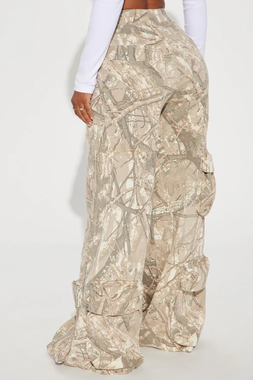 Camouflage cargo pants worn by a person on a white background