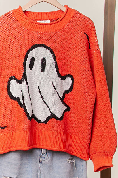 Orange sweater with a ghost design on a hanger