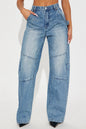 Blue jeans worn by a person on a white background