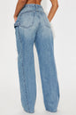 Blue jeans worn by a person on a white background