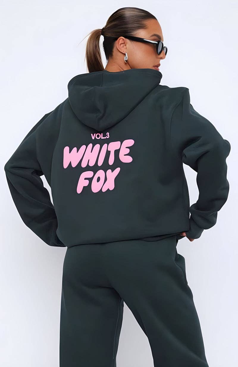Person wearing a black hoodie with 'White Fox' text on the back against a white background