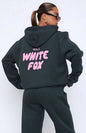 Person wearing a black hoodie with 'White Fox' text on the back against a white background