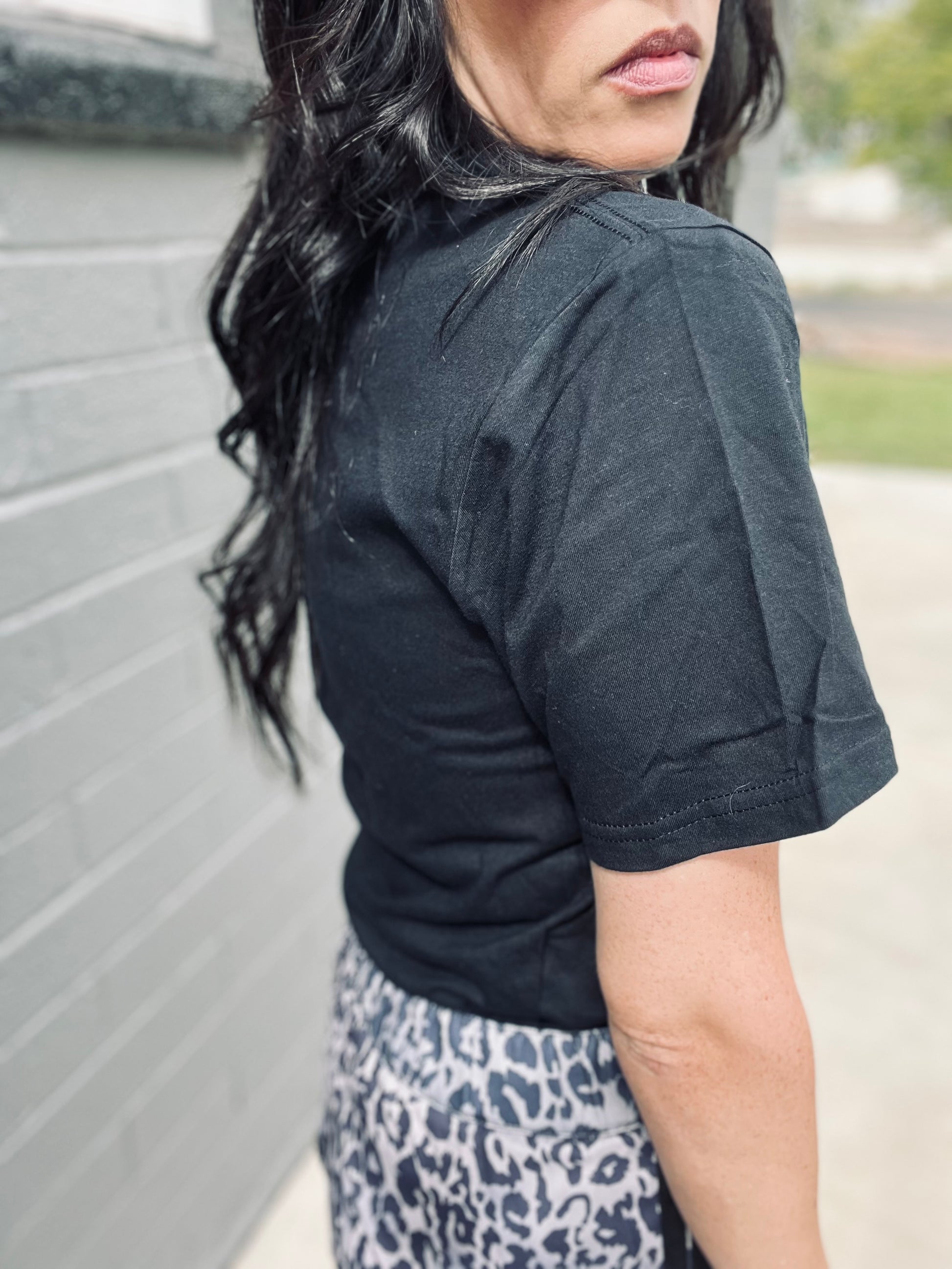 Person wearing a black shirt with a blurred background