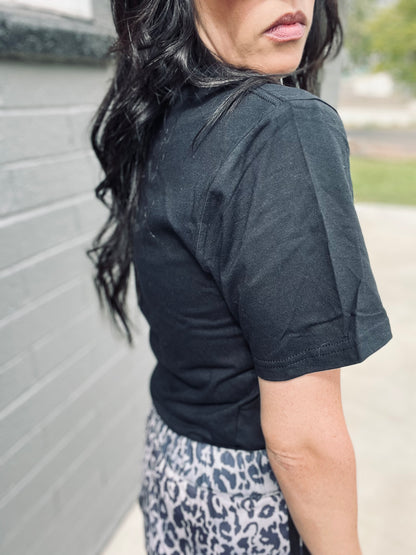 Person wearing a black shirt with a blurred background