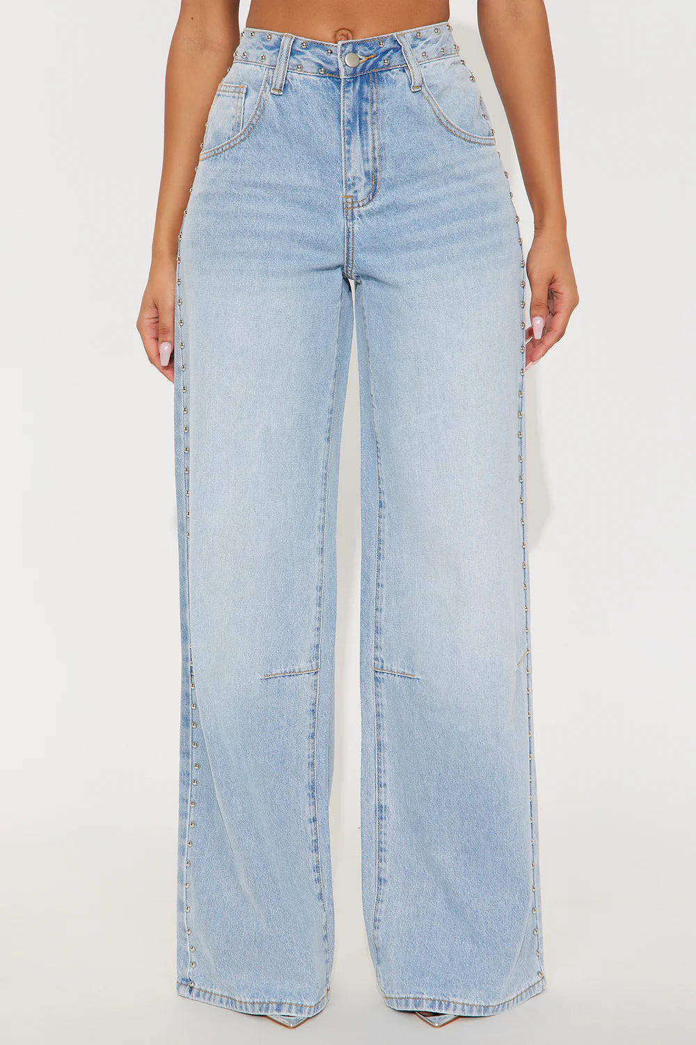 Light blue jeans worn by a person on a white background