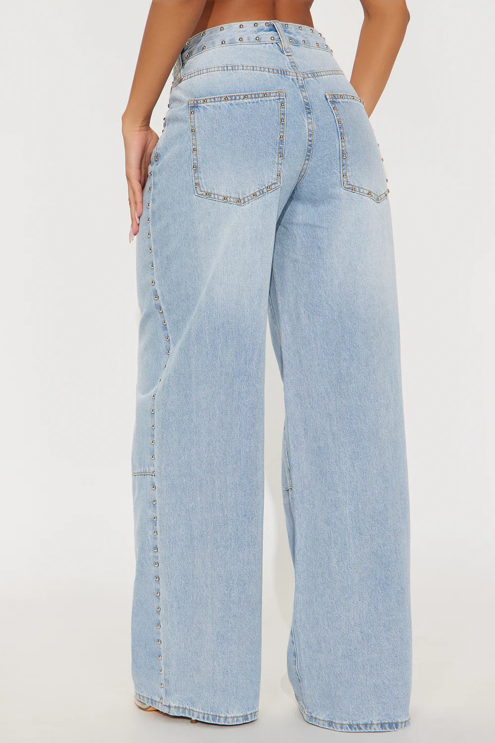 Light blue jeans worn by a person on a white background