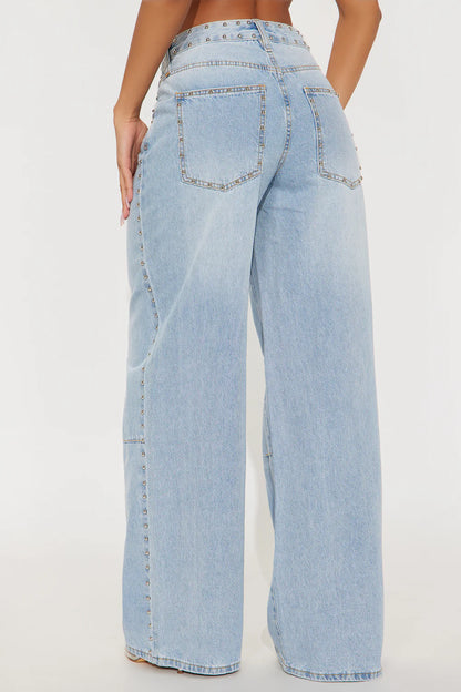 Light blue jeans worn by a person on a white background