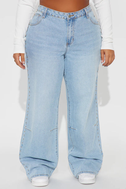 Light blue wide-leg jeans worn by a person on a white background