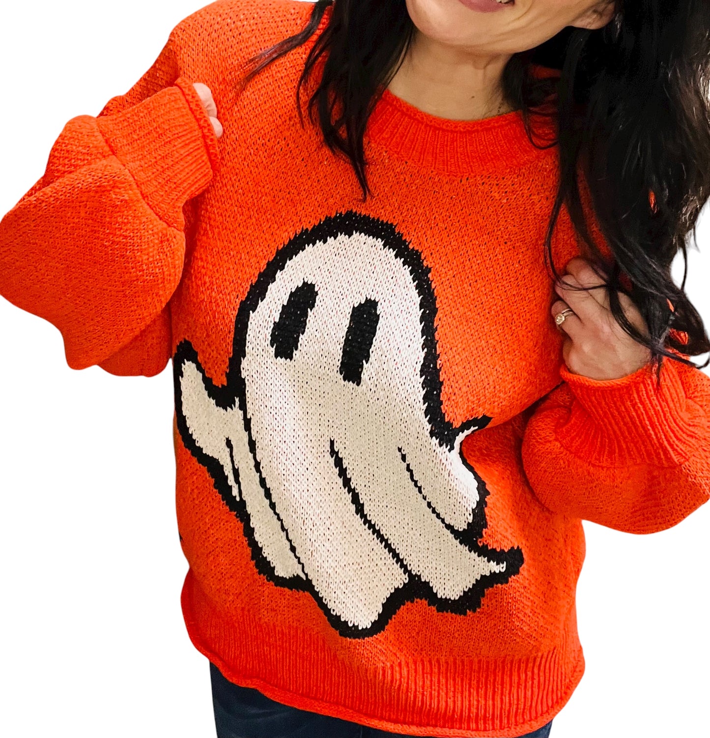 Person wearing an orange sweater with a ghost design on a white background